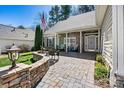 Inviting front porch with stone columns and comfortable seating area, perfect for relaxing at 7331 Sedgebrook W Dr, Stanley, NC 28164
