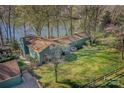 Aerial view of a lovely home with a well-maintained lawn and lake access at 7611 Buckland Rd, Charlotte, NC 28278