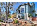 Charming exterior elevation with multilevel decks, a stone foundation, and beautiful landscaping at 7611 Buckland Rd, Charlotte, NC 28278
