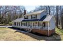 Charming two-story home with black shutters and a welcoming front porch at 8125 Appaloosa Ln, Charlotte, NC 28215