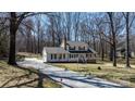 Classic two-story home with a long driveway and mature trees at 8125 Appaloosa Ln, Charlotte, NC 28215