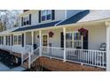 Inviting front porch with white railings and hanging floral baskets at 8125 Appaloosa Ln, Charlotte, NC 28215