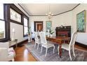 Bright dining room with hardwood floors, fireplace, and updated chandelier at 819 Sunnyside Ave, Charlotte, NC 28204