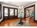Elegant entryway featuring hardwood floors, chandelier, and beautiful trim at 819 Sunnyside Ave, Charlotte, NC 28204