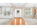 Inviting foyer with hardwood floors, decorative columns, and abundant natural light through large windows at 963 Brookdale Ln, Stanley, NC 28164
