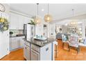 Eat in kitchen island with stainless steel appliances, granite countertops and decorative pendant lighting at 963 Brookdale Ln, Stanley, NC 28164