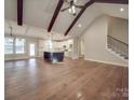 Open-concept living space with vaulted ceilings, exposed beams, hardwood floors, and a modern kitchen with an island at 0000 Trull Hinson Rd # 2, Wingate, NC 28174