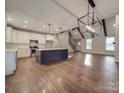 Spacious living room and kitchen with hardwood floors, a large island, white cabinets, and an open floor plan at 0000 Trull Hinson Rd # 2, Wingate, NC 28174