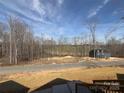 Scenic view of a gray house nestled among trees, with a glimpse of the surrounding landscape at 1022 Harrogate Dr, Bessemer City, NC 28016