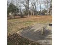 Spacious backyard featuring a concrete patio area surrounded by mature trees and foliage at 1111 Pondella Dr # 66, Charlotte, NC 28213