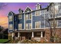 Striking blue townhouse exterior with brick facade and inviting covered entry at 1525 Walnut View Dr, Charlotte, NC 28208