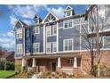 Attractive blue townhouse with brick base, complemented by well-maintained landscaping at 1525 Walnut View Dr, Charlotte, NC 28208