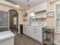 Bright kitchen featuring white cabinets, subway tile backsplash, and open shelving for storage at 163 Brookshire Dr, Fort Mill, SC 29715