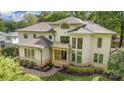 Stately home boasts a turret, manicured landscaping, and inviting column-supported front entryway at 1665 Sterling Rd, Charlotte, NC 28209