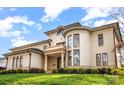 Elegant house features a rounded tower section, classic columns, and landscaped grounds under a bright sky at 1665 Sterling Rd, Charlotte, NC 28209