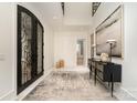 Bright foyer showcasing the decorative front doors, marble floors, and designer console table at 1665 Sterling Rd, Charlotte, NC 28209