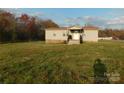 Charming single story home featuring a small porch, traditional windows, and vinyl siding at 1909 E Lawyers Rd, Monroe, NC 28110