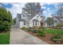 Well-maintained home with a driveway, manicured lawn and garden, and a classic painted white brick exterior at 2237 Colony Rd, Charlotte, NC 28209