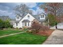 Beautifully maintained white home featuring manicured landscaping, stone accents, and a well-kept lawn at 2237 Colony Rd, Charlotte, NC 28209