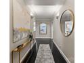 Elegant hallway featuring dark wood floors, stylish decor, and tasteful lighting creating a welcoming ambiance at 2445 Selwyn Ave, Charlotte, NC 28209