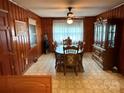 Cozy wood paneled dining room with traditional furnishings and natural light at 2730 Medlin Rd, Monroe, NC 28112
