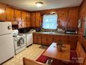 Classic eat-in kitchen featuring wood cabinets and white appliances at 2730 Medlin Rd, Monroe, NC 28112