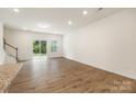 Bright living room with wood floors, patio access, and neutral wall paint at 2749 Yeager Nw Dr, Concord, NC 28027