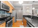 Modern kitchen showcasing stainless appliances, wooden cabinets, and granite countertops at 300 W 5Th St # 224, Charlotte, NC 28202