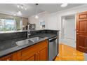 Charming kitchen showcasing wood cabinets, granite counters, and a stainless steel dishwasher at 300 W 5Th St # 224, Charlotte, NC 28202