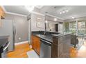 Well-lit kitchen featuring stainless steel appliances and a breakfast bar overlooking the living area at 300 W 5Th St # 224, Charlotte, NC 28202