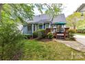 Inviting backyard featuring a wooden deck with outdoor seating and lush landscaping at 306 Ashby Dr, Davidson, NC 28036