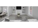Bright living room featuring neutral walls, carpet, and built-in shelving at 310 Pineview St, Kannapolis, NC 28083