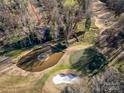 An aerial view of the property next to the golf course and pond creates a serene atmosphere at 32 Fairway Rdg, Lake Wylie, SC 29710