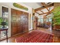 Grand foyer with hardwood floors, a large rug, and exposed ceiling beams, creating a stunning entry at 32 Fairway Rdg, Lake Wylie, SC 29710