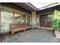 Inviting front porch features stone flooring and a bench, offering a welcoming entrance at 32 Fairway Rdg, Lake Wylie, SC 29710