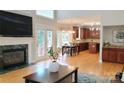 Spacious living room features a fireplace, hardwood floors, and kitchen view at 3304 Taviston Dr, Waxhaw, NC 28173