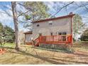 View of the back of the house featuring a deck and large backyard at 335 Deep Forest Ct, Gastonia, NC 28056