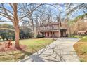 Spacious home with a long driveway, large yard and a welcoming covered front porch at 335 Deep Forest Ct, Gastonia, NC 28056