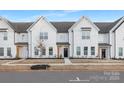 Charming new construction townhouse showcasing a white exterior, dark trim, and welcoming front entrance at 336 Ginsberg Rd, Rock Hill, SC 29732
