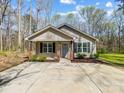 Attractive single-story home with neutral siding, brick accents, a well-manicured lawn, and a spacious concrete driveway at 350 Belvedere Nw Dr, Concord, NC 28027