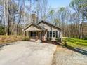 Attractive single-story home with neutral siding, brick accents, manicured landscaping, and a concrete driveway at 350 Belvedere Nw Dr, Concord, NC 28027