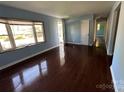 Inviting living room featuring hardwood floors, natural light and an open doorway at 3915 Crestridge Dr, Charlotte, NC 28217
