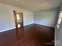 Spacious living room boasting wood floors and a view into another room at 3915 Crestridge Dr, Charlotte, NC 28217