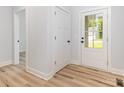 Bright entryway features wood flooring, a coat closet, and a glass-paneled front door at 409 Bost St, Kannapolis, NC 28081