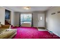 Cozy living room with bright carpet and a large window overlooking the outdoors at 455 Pinhook Loop Rd, Gastonia, NC 28056