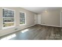 Bright living room with large windows and modern gray wood flooring at 4931 Galax Dr, Charlotte, NC 28213