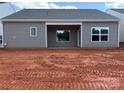 View of the home's back exterior with siding, windows and a covered patio area at 5708 Skinny Dr, Charlotte, NC 28215