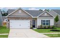 Charming single-story home featuring a stone facade, attached garage, and a well-manicured lawn at 5708 Skinny Dr, Charlotte, NC 28215
