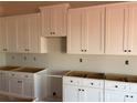 A view of the kitchen with white cabinets and black hardware at 5708 Skinny Dr, Charlotte, NC 28215