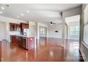 Modern kitchen featuring stainless steel appliances, a central island, and cherry wood cabinetry at 8513 Garden View Dr, Charlotte, NC 28277